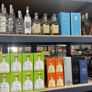 a shelf full of liquor bottles