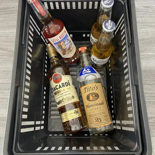 a basket full of liquor bottles