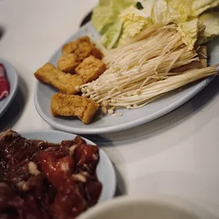 Tofu puff, enoki mushroom, Napa cabbage, marinated pork