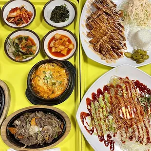 Kimchi Stew, Seafood Tofu Soup, Bulgogi, Spicy cold noodles, pork Katsu and some side dishes.