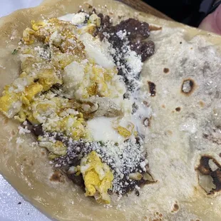 a hand holding a taco