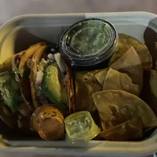 Beef and fish taco with chips and guacamole