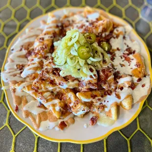 LOADED FRIES
Steak fries, cheese, spillway sauce, ranch, bacon and our house pickled peppers.