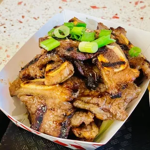 a bowl of noodles and a plate of meat