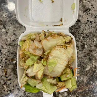 a closeup of a hot tuna sushi in a styrofoam container