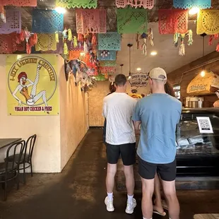 a group of people standing in a restaurant