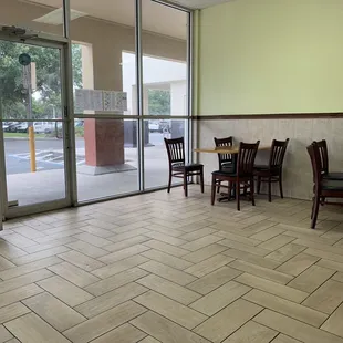 4 wooden tables that each sit four. A very sparse dining area for a mostly takeout establishment
