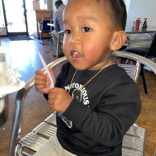 a toddler eating a piece of cake