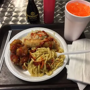 Fried rice, lo mein noodles, sesame chicken, egg roll, orange soda--an excellent Thai meal!