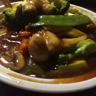 Szechuan Chicken sitting in a bowl full of oil.