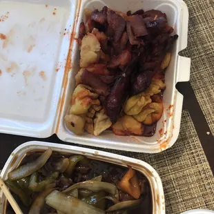 two take out containers of food with chopsticks