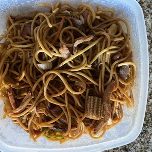 a plate of noodles and meat