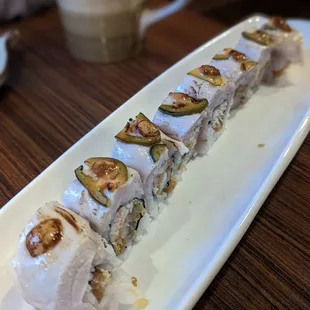 Hot Stuff -  crab meat, tempura shrimp, topped with torched hamachi, jalapeno, spicy aioli, ponzu