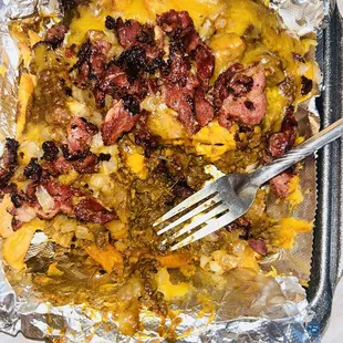 Chili cheese fries with pastrami, grilled onions