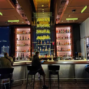 two people sitting at the bar
