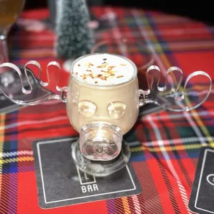 a glass of coffee with a skull on it