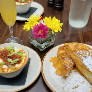 Chorizo &amp; cheese grits, pumpkin cream cheese stuffed french toast and pineapple mimosa.