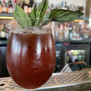 a drink in a glass with a garnish