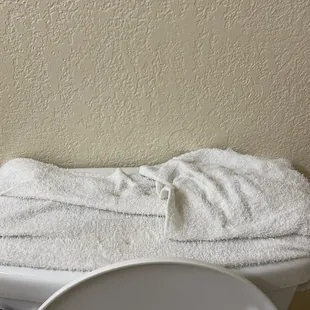 Soaking wet towel from water dripping from above my toilet from another room