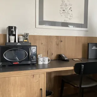 Great workspace!  Mini fridge tucked away in the lovely cabinet.