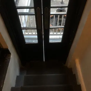 1/2 flight of stairs leading to an exterior balcony