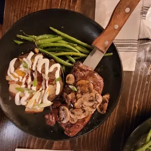 New York steak Demi glaze sautéd mushroom loaded bake potato with green beans