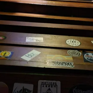 a wooden bench with stickers on it