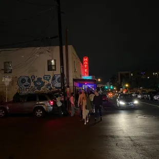the neon sign of a motel at night