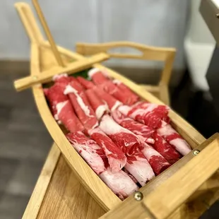raw meat in a wooden boat
