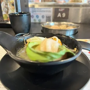 Bok choy and a dumpling with the veggie base