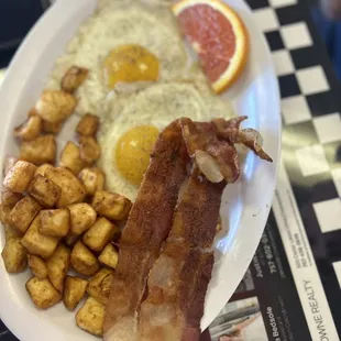 Sunny side up, crispy potatoes. She special orders her bacon from Indiana which is thick cut.
