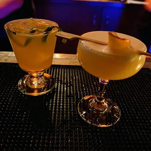 two cocktails on a bar