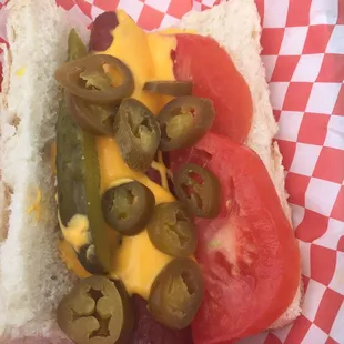 JC (jalapeños and cheddar) with tomato and pickle on 1/4 lb Nathan's all beef dog.