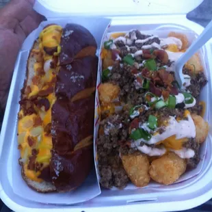 Hot Mess Tots and the bacon wrapped Nathan's hotdog covered with cheese sauce,bacon bits, onions, and a drizzle of mustard...