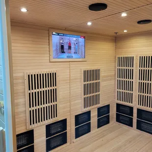 Inside the sauna showing the TV with our three virtual instructors. Three instructors showing beginner, intermediate, and advances posses