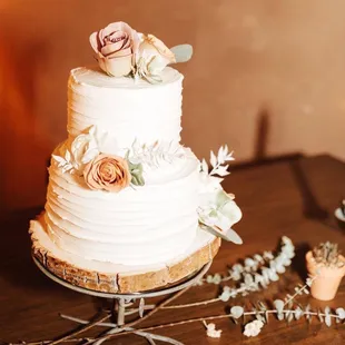 a wedding cake with flowers on top