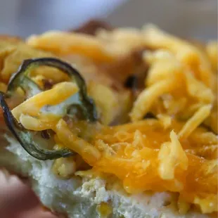 a person holding a piece of pizza