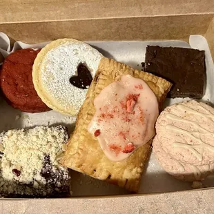 Red velvet cookie sandwich, raspberry linzor, brownie, strawberry fruit melt cookies, strawberry champagne pop tart and cherry fruit bar.
