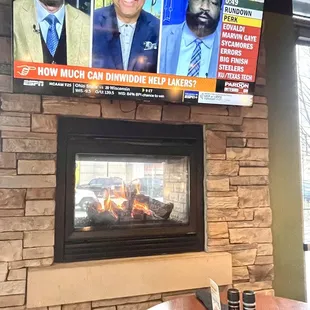 a fireplace with a tv above it