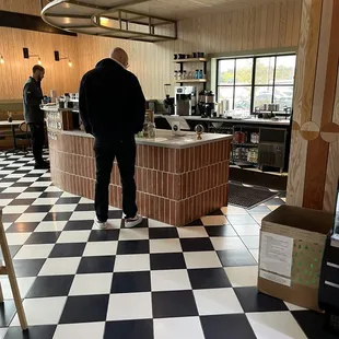a man standing in a coffeehouse