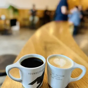 Black coffee and latte at the high-top table right by the entrance