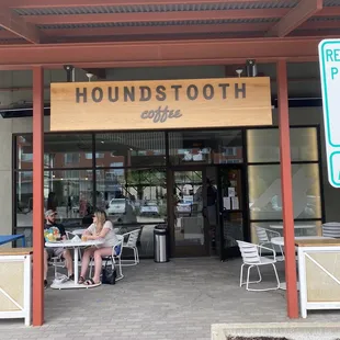people sitting at tables outside