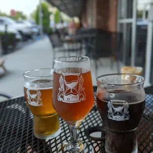three glasses of beer on a table
