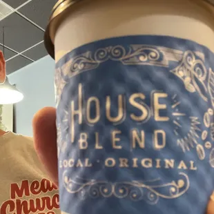 a man holding a cup of coffee