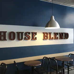 a blue wall with a sign that says house blend