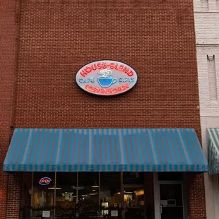a brick building with a blue awning