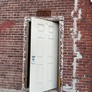 Door in the alley to the left of four score coffee