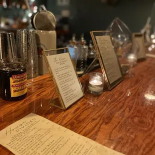 a bar with a menu and bottles of liquor