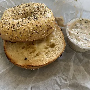 Everything bagel toasted with butter and veggie cream cheese on the side.