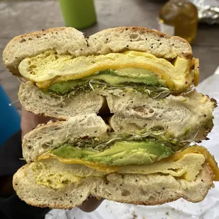 a person holding a sandwich